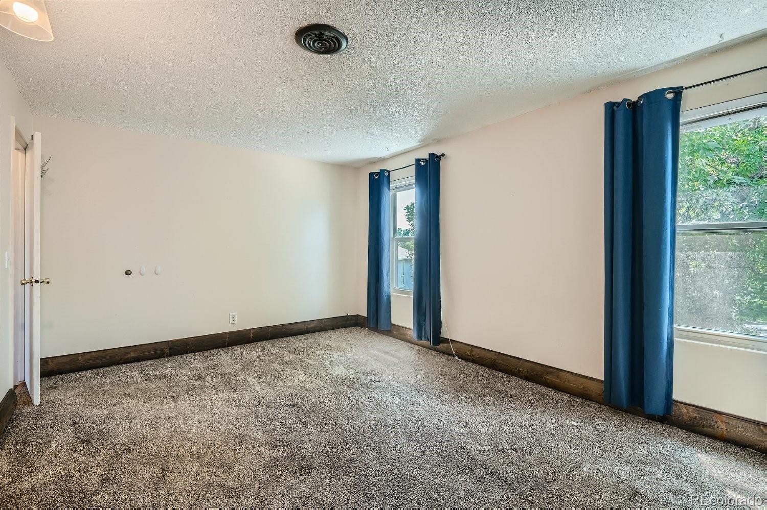 11099 Fairfax Circle Thornton, CO 80233 - Photo 21 of 33 an empty room with windows