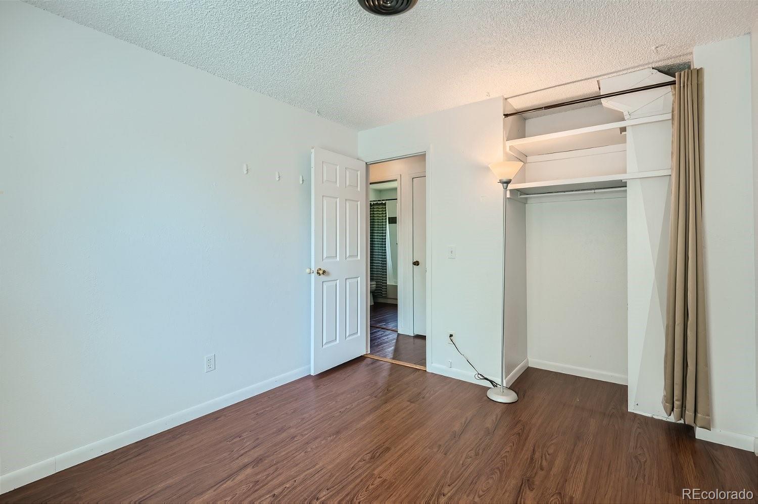 11099 Fairfax Circle Thornton, CO 80233 - Photo 25 of 33 an empty room with wooden floor and closet