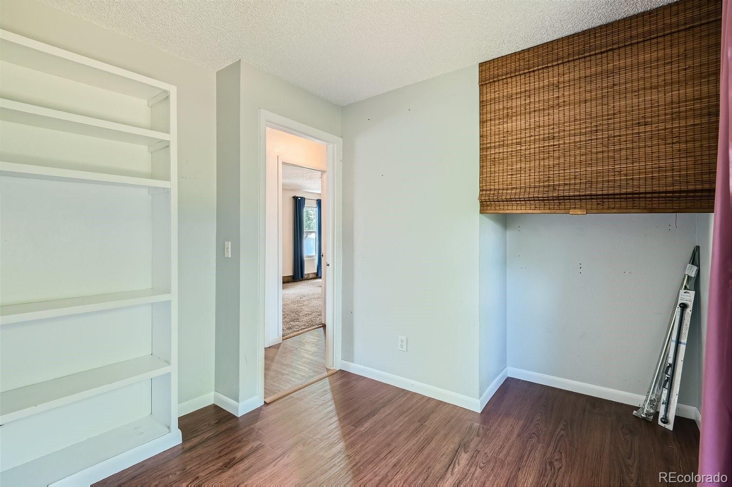 11099 Fairfax Circle Thornton, CO 80233 - Photo 27 of 33 a view of a room with wooden floor and a window