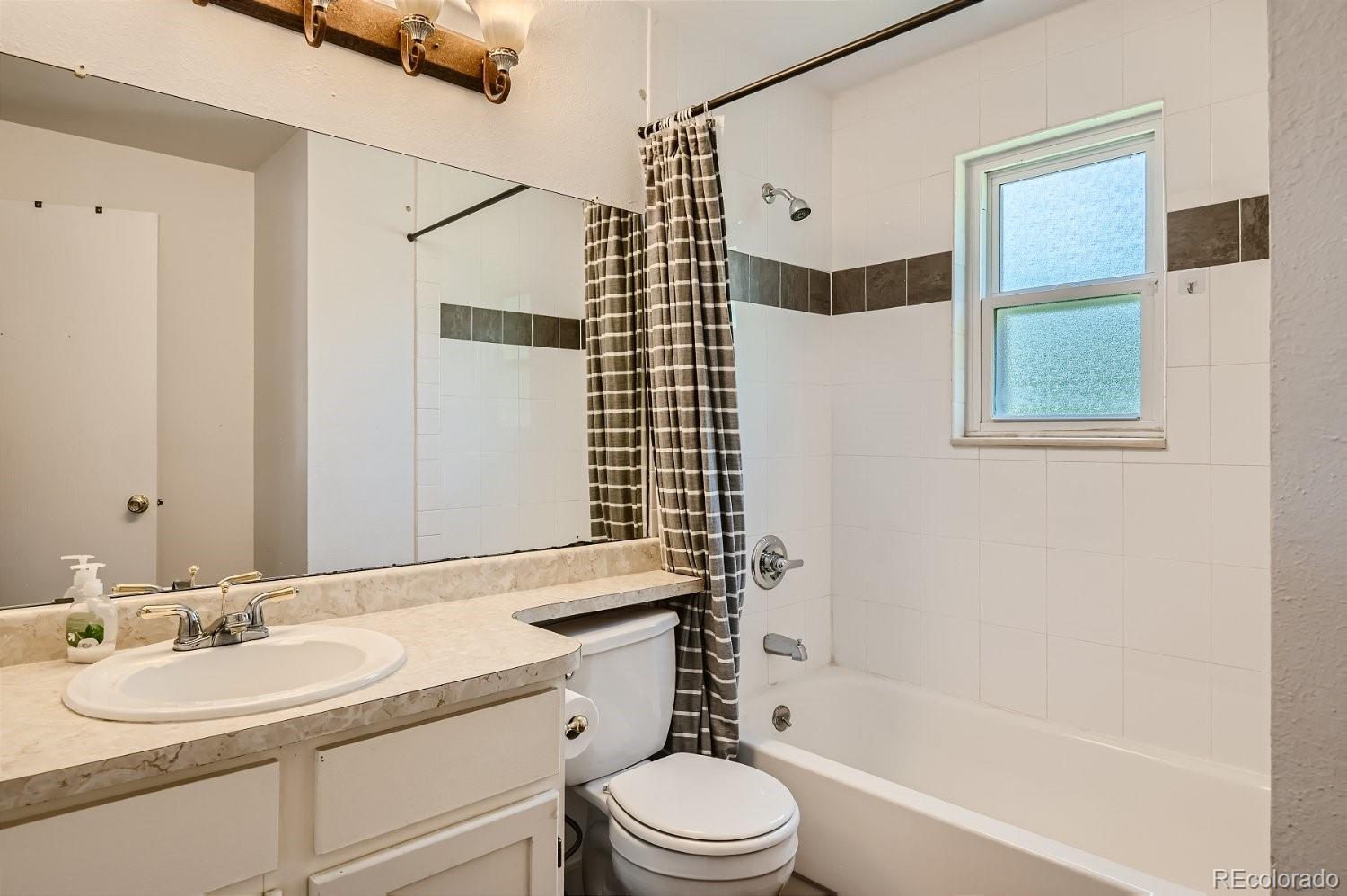11099 Fairfax Circle Thornton, CO 80233 - Photo 28 of 33 a bathroom with a granite countertop sink toilet and shower