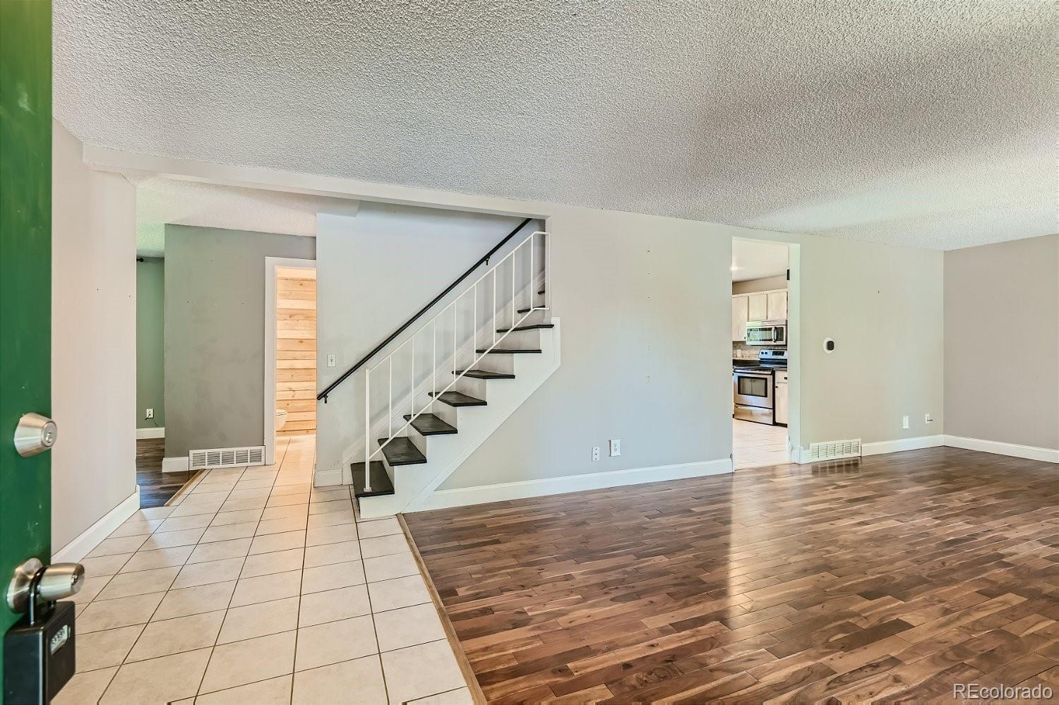 11099 Fairfax Circle Thornton, CO 80233 - Photo 7 of 33 a view of entryway and hall with wooden floor