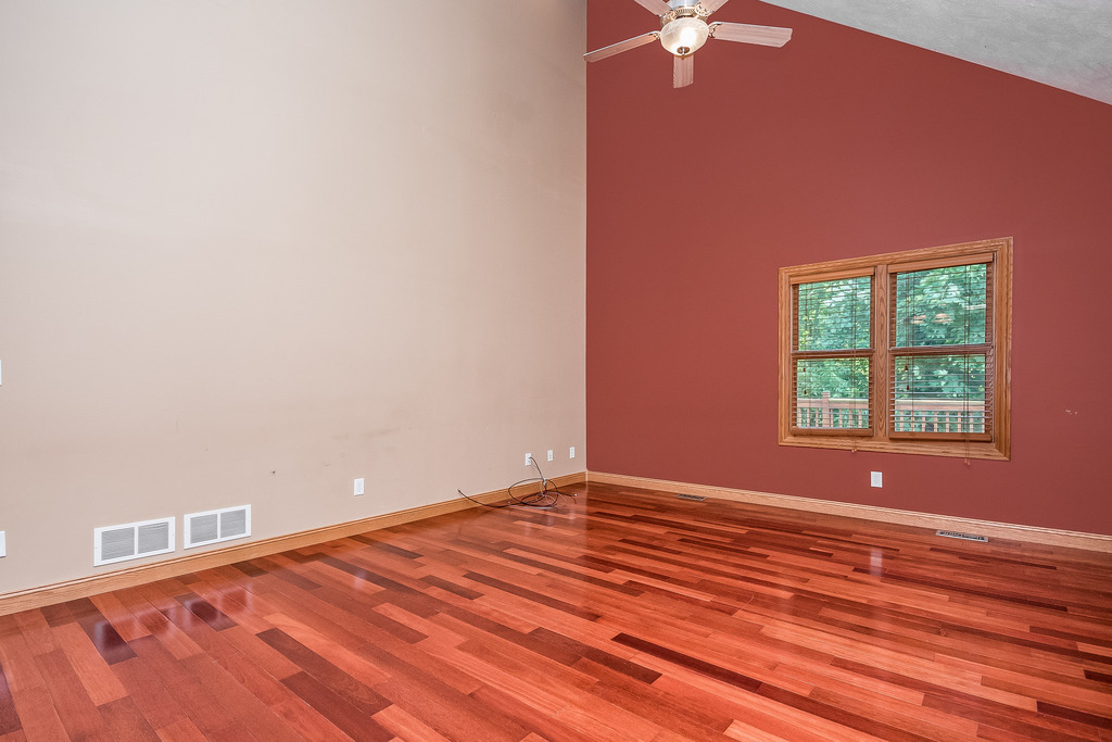 331 Rickert Street Hinckley, IL 60520 - Photo 4 of 19 an empty room with a chandelier fan and windows