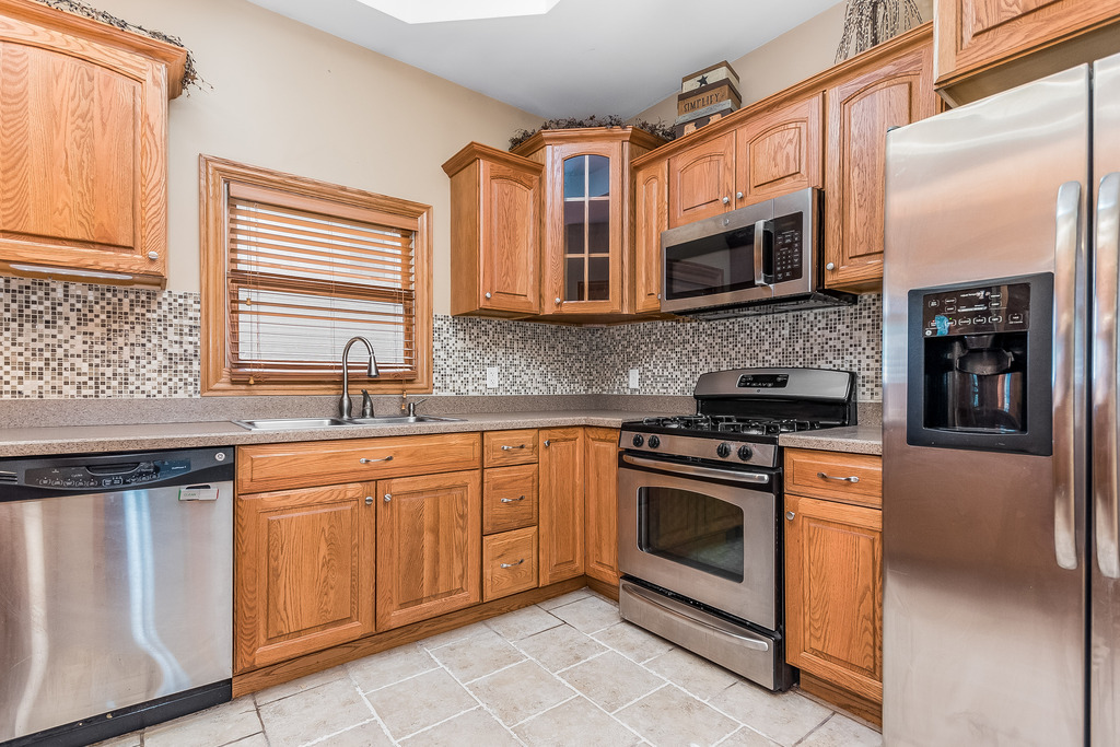 331 Rickert Street Hinckley, IL 60520 - Photo 5 of 19 a kitchen with stainless steel appliances granite countertop a stove and a sink
