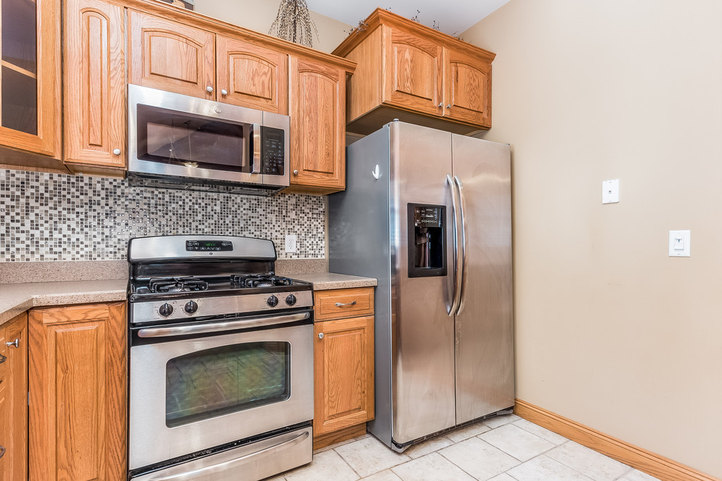 331 Rickert Street Hinckley, IL 60520 - Photo 6 of 19 a kitchen with stainless steel appliances granite countertop a stove microwave and refrigerator