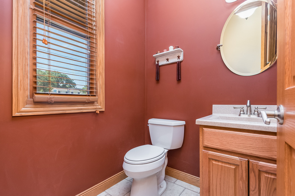 331 Rickert Street Hinckley, IL 60520 - Photo 7 of 19 a bathroom with a toilet a sink and mirror