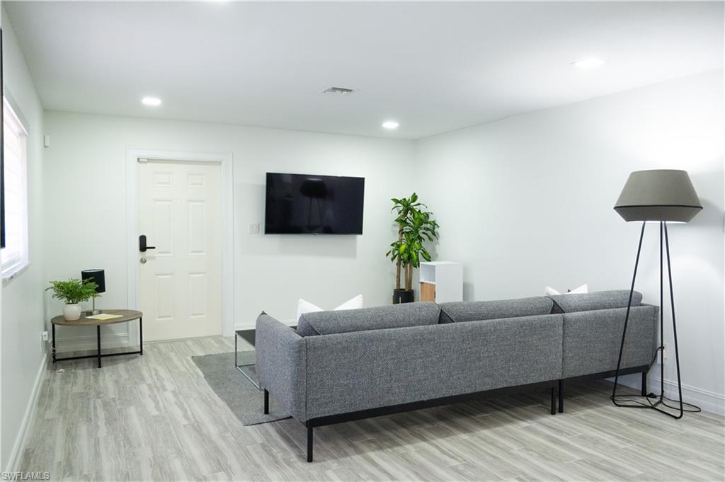 136 Harrison Road, Unit L3 Naples, FL 34112 - Photo 12 of 50 a living room with furniture and a flat screen tv