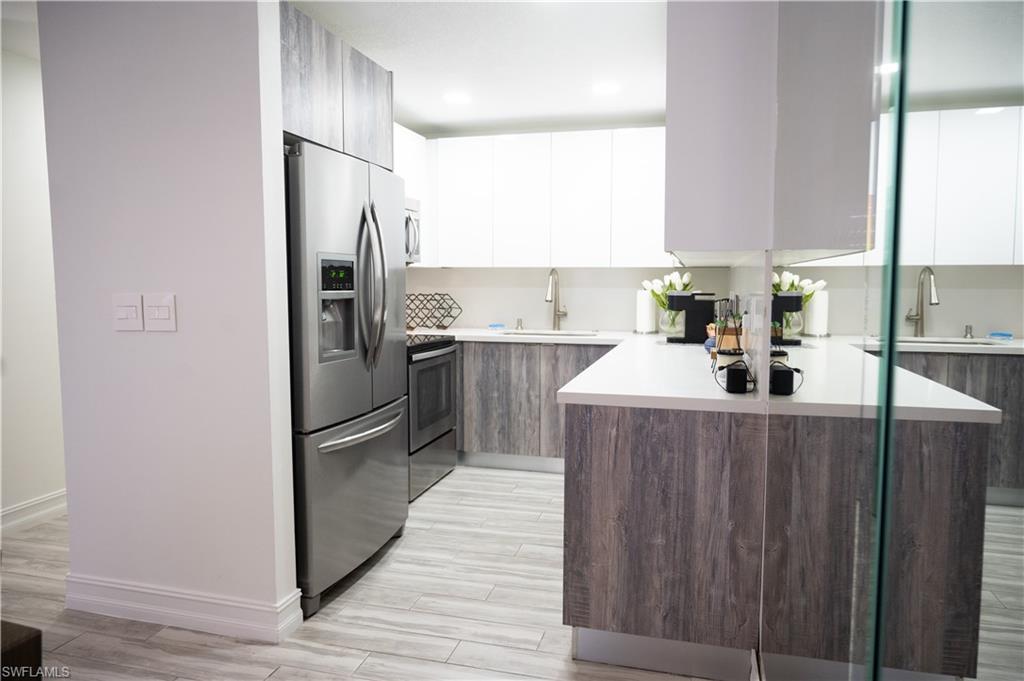 136 Harrison Road, Unit L3 Naples, FL 34112 - Photo 16 of 50 a kitchen with stainless steel appliances a refrigerator and a sink