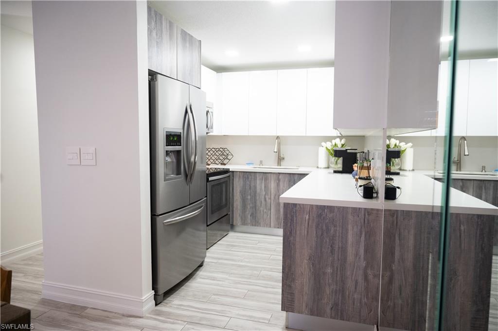 136 Harrison Road, Unit L3 Naples, FL 34112 - Photo 18 of 50 a kitchen with stainless steel appliances a refrigerator and a sink