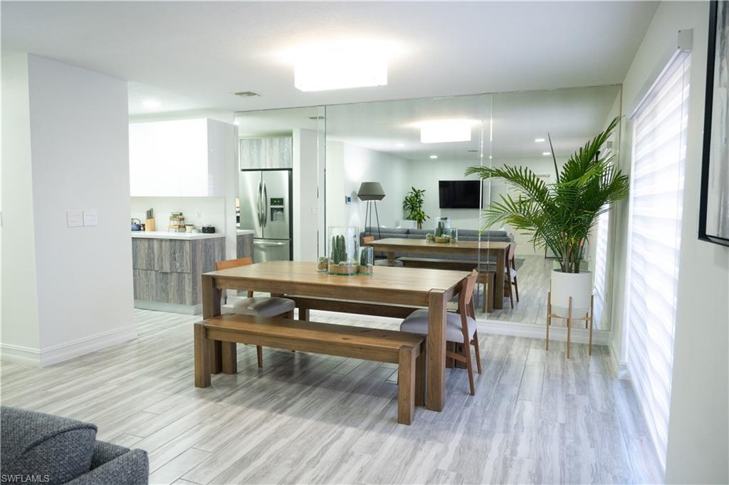 136 Harrison Road, Unit L3 Naples, FL 34112 - Photo 19 of 50 a view of a dining room with furniture and wooden floor