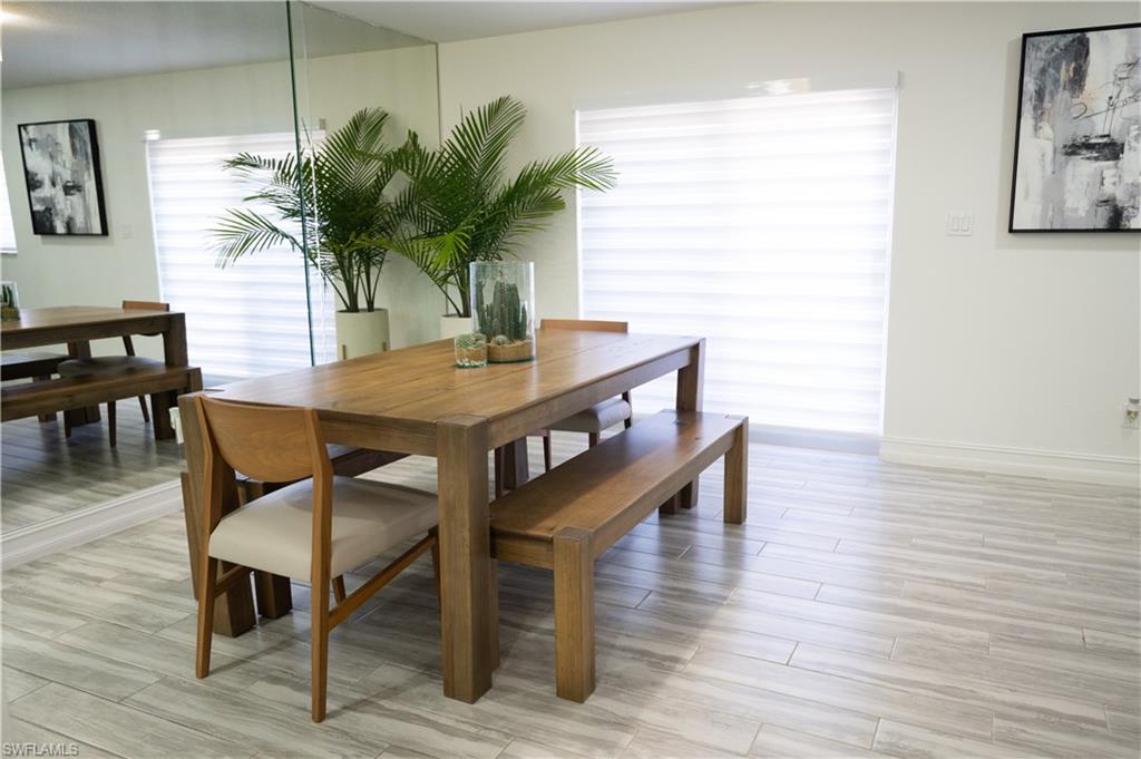 136 Harrison Road, Unit L3 Naples, FL 34112 - Photo 20 of 50 a view of a dining room with furniture and wooden floor