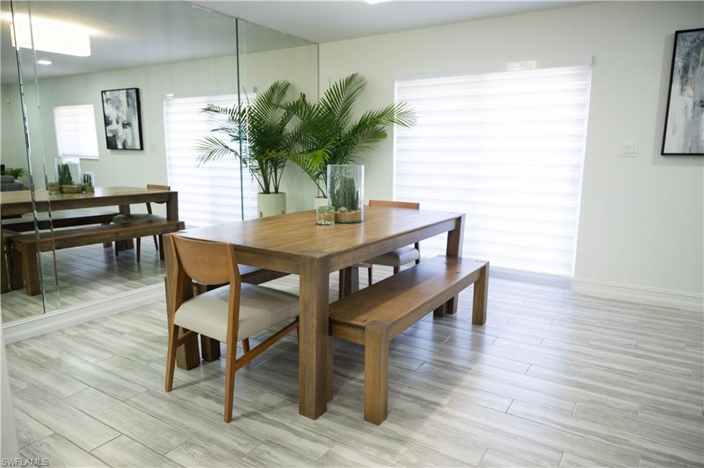 136 Harrison Road, Unit L3 Naples, FL 34112 - Photo 21 of 50 a view of a dining room with furniture and wooden floor