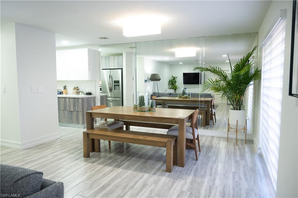 136 Harrison Road, Unit L3 Naples, FL 34112 - Photo 22 of 50 a view of a dining room with furniture and wooden floor