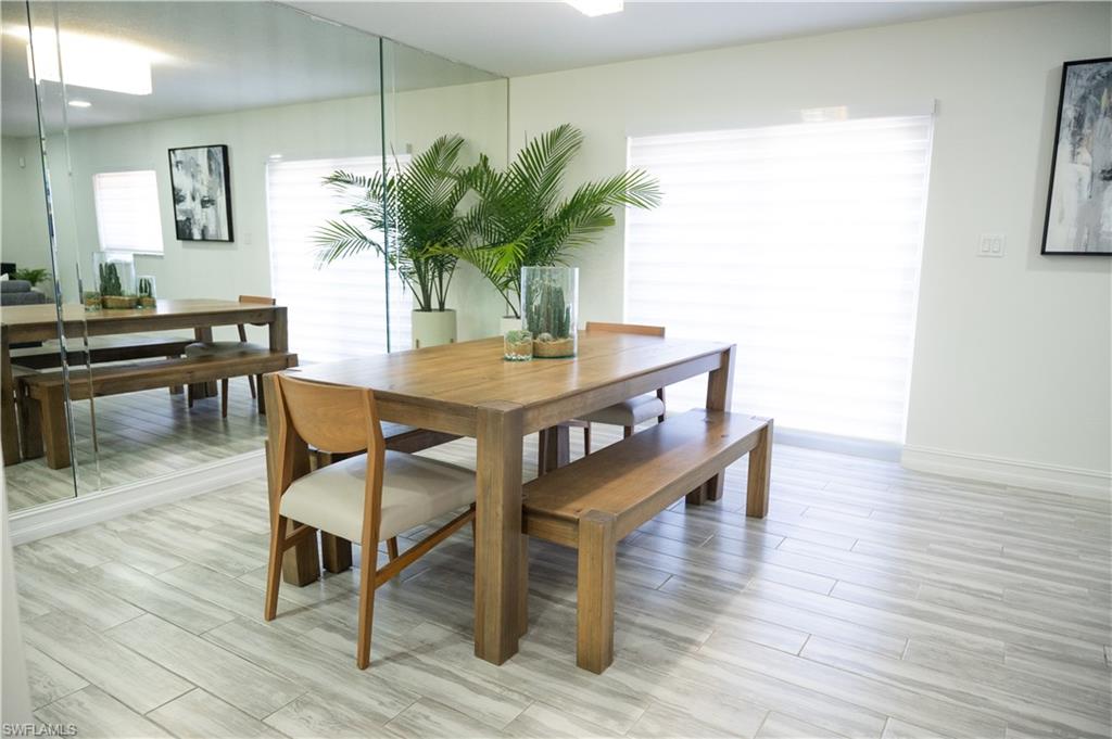 136 Harrison Road, Unit L3 Naples, FL 34112 - Photo 23 of 50 a view of a dining room with furniture and wooden floor