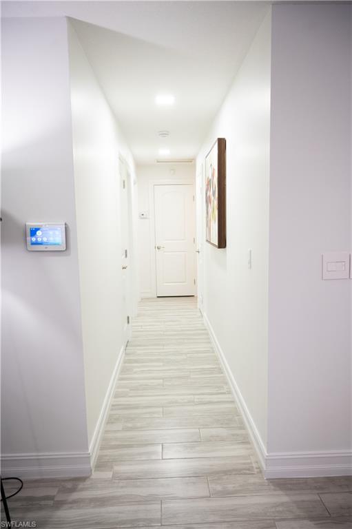136 Harrison Road, Unit L3 Naples, FL 34112 - Photo 24 of 50 a view of a hallway with wooden floor