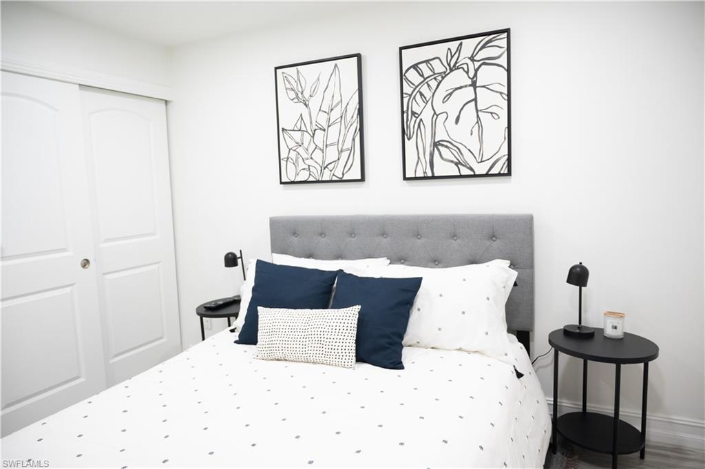 136 Harrison Road, Unit L3 Naples, FL 34112 - Photo 25 of 50 a bedroom with a bed and painting on the wall