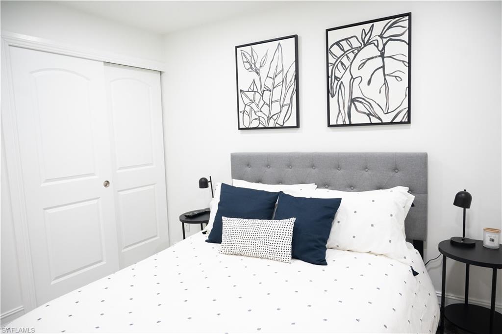 136 Harrison Road, Unit L3 Naples, FL 34112 - Photo 29 of 50 a large bed in a white room