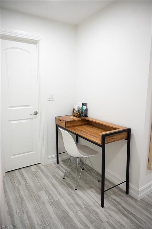 136 Harrison Road, Unit L3 Naples, FL 34112 - Photo 40 of 50 a room with a table and wooden floor