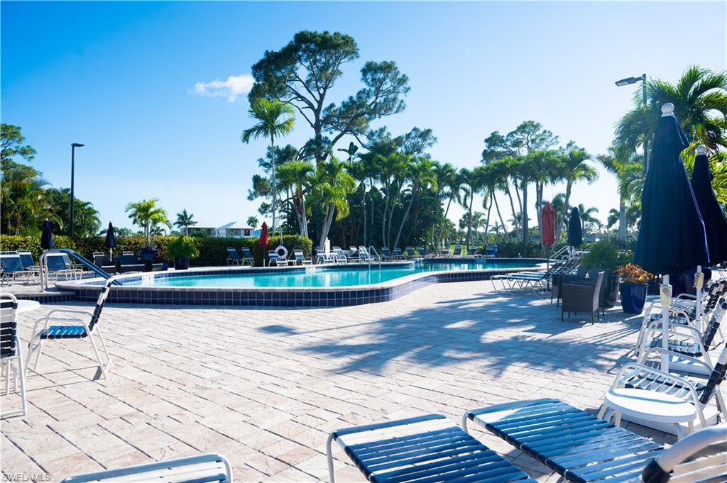 136 Harrison Road, Unit L3 Naples, FL 34112 - Photo 50 of 50 a view of a swimming pool with chairs