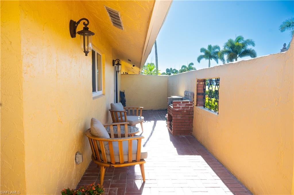 136 Harrison Road, Unit L3 Naples, FL 34112 - Photo 5 of 50 a balcony with table and chairs