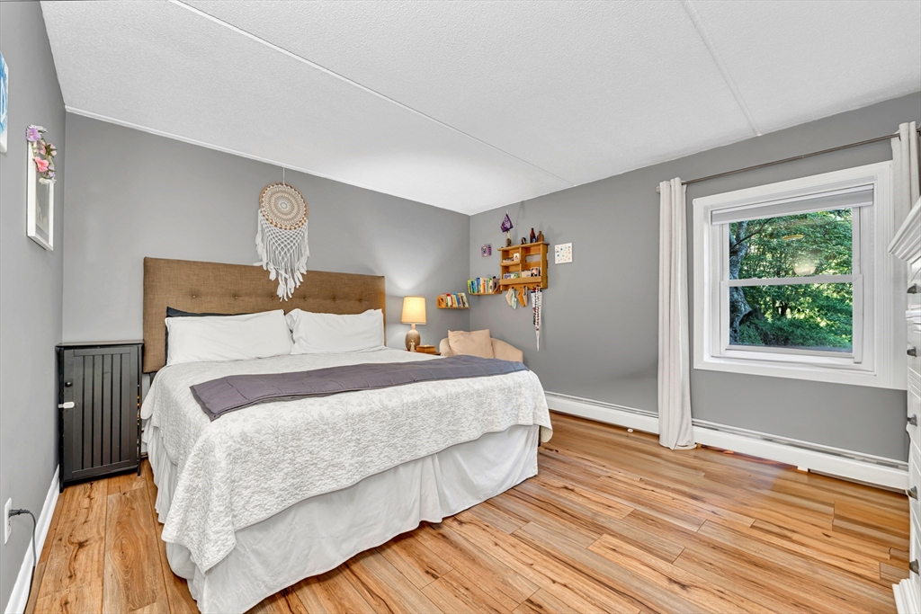 20 Lawrence Road, Unit 5 Rowley, MA 01969 - Photo 10 of 25 a bedroom with a bed and wooden floor