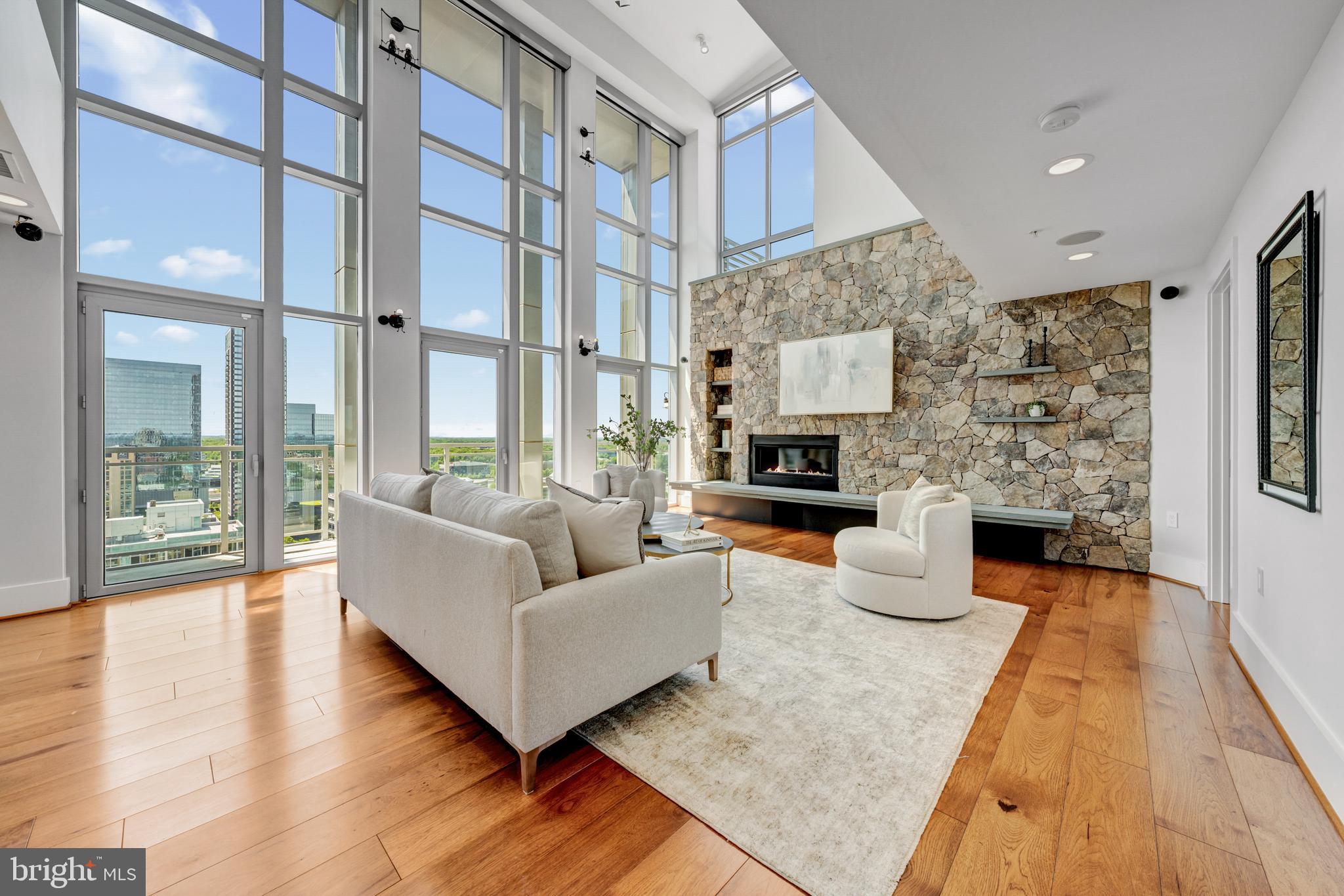11990 Market Street, Unit 2112 Reston, VA 20190 - Photo 1 of 92 a living room with fireplace furniture and a wooden floor