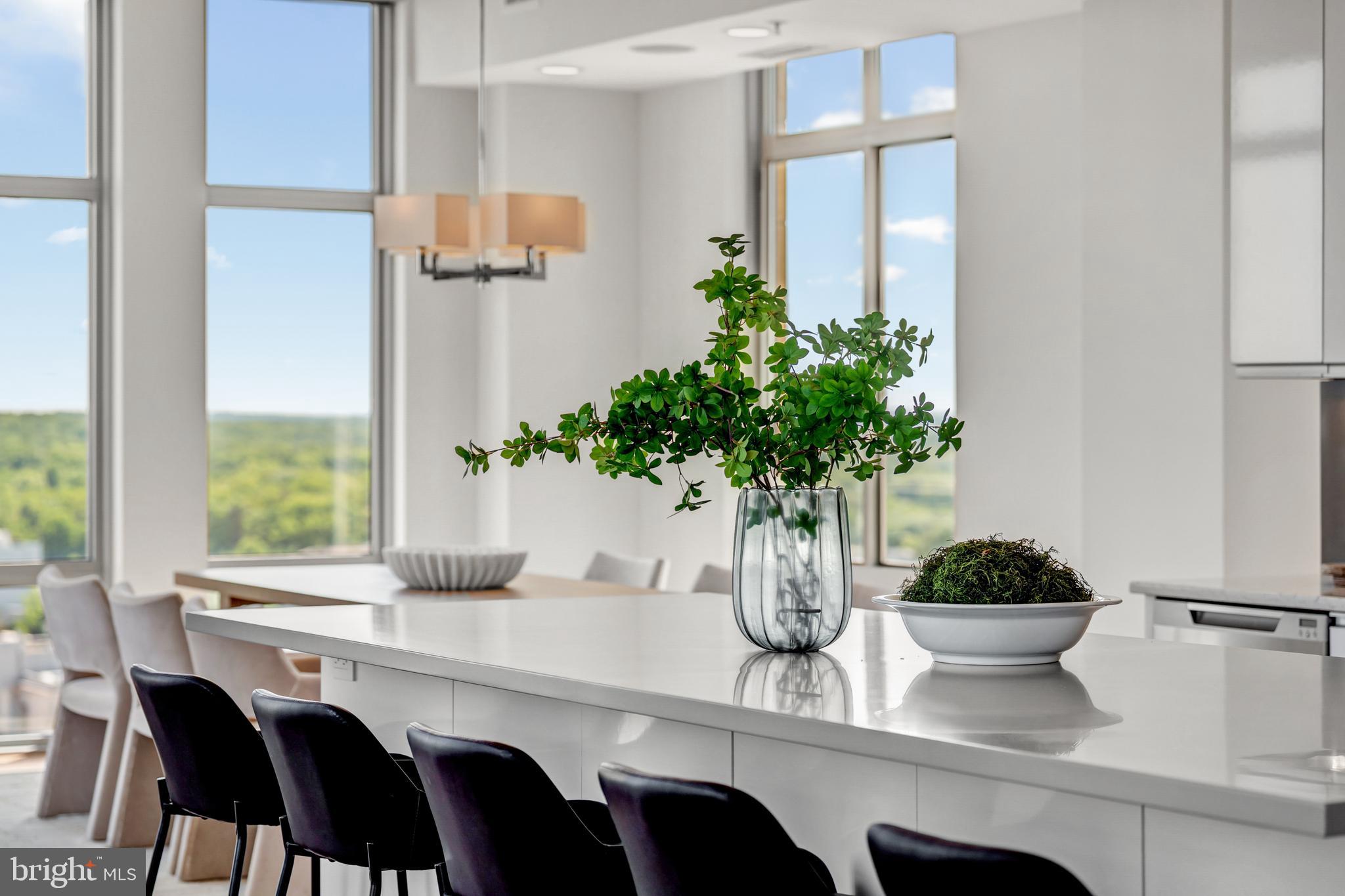 11990 Market Street, Unit 2112 Reston, VA 20190 - Photo 14 of 92 a vase of flowers sitting on a table with a glass window