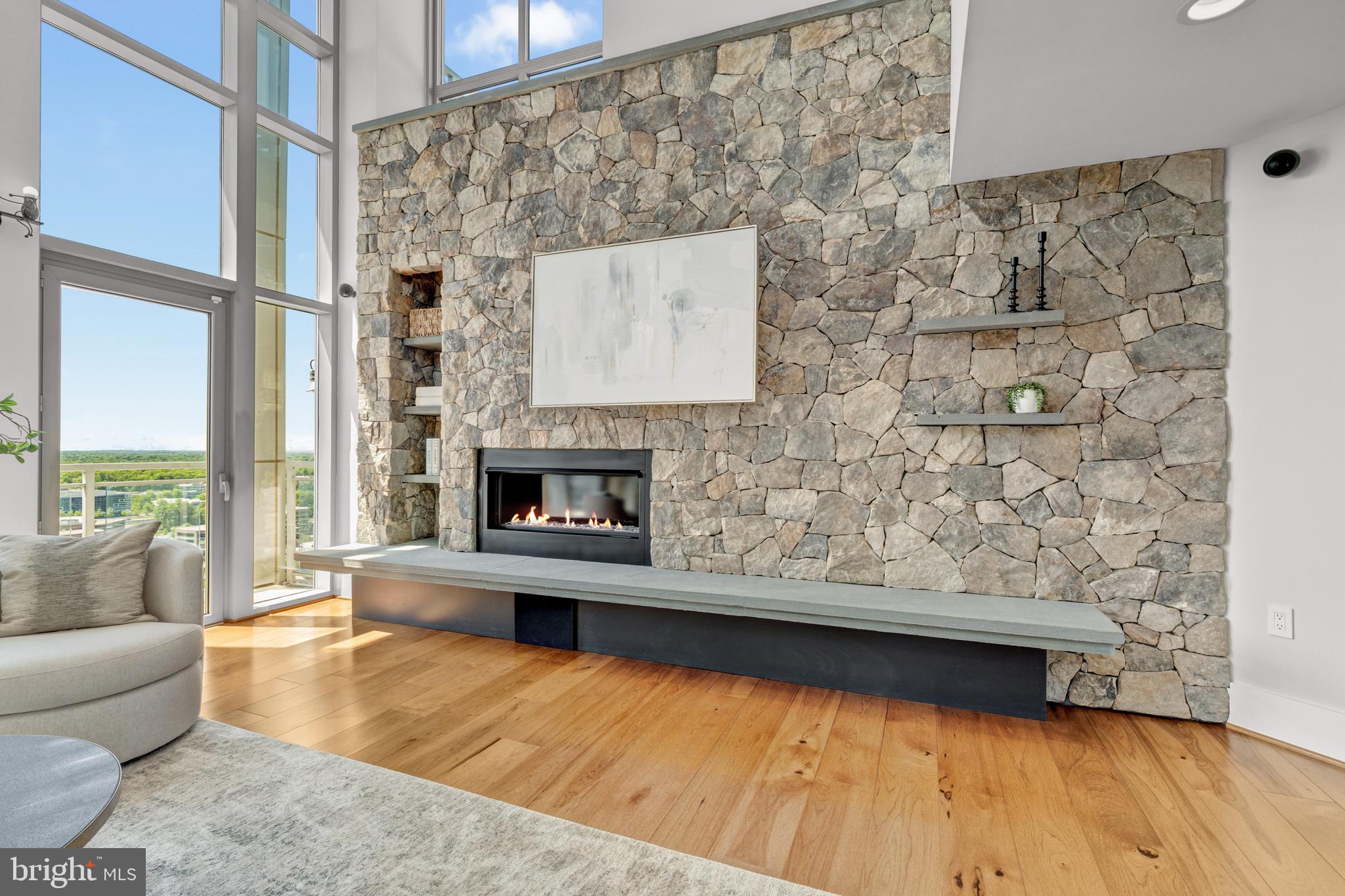 11990 Market Street, Unit 2112 Reston, VA 20190 - Photo 2 of 92 a living room with a couch and a fireplace