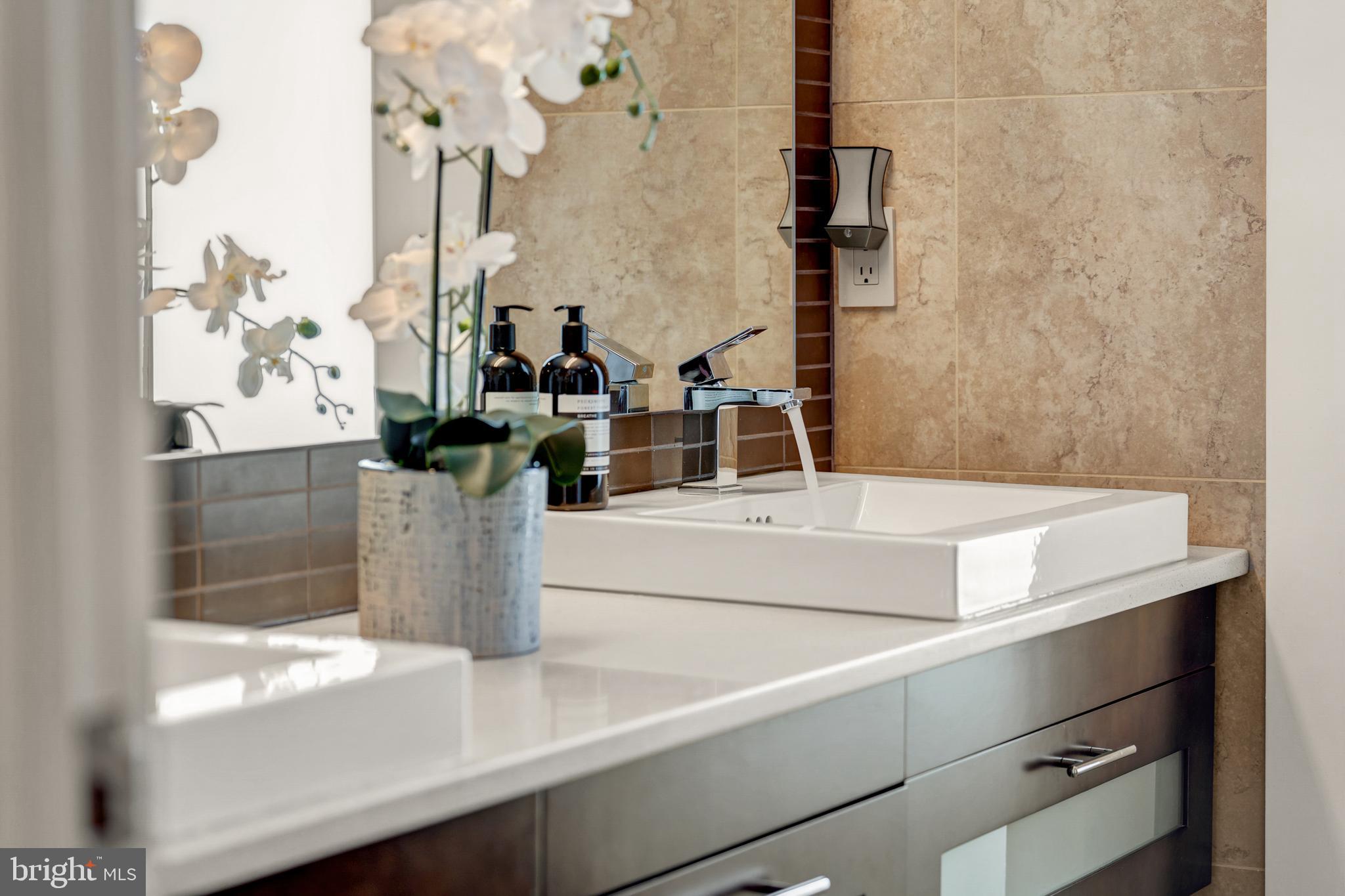 11990 Market Street, Unit 2112 Reston, VA 20190 - Photo 28 of 92 a bathroom with a sink and a mirror