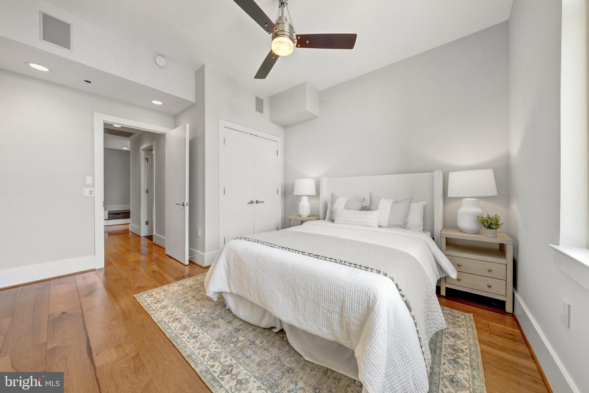 11990 Market Street, Unit 2112 Reston, VA 20190 - Photo 29 of 92 a bedroom with a bed and wooden floor