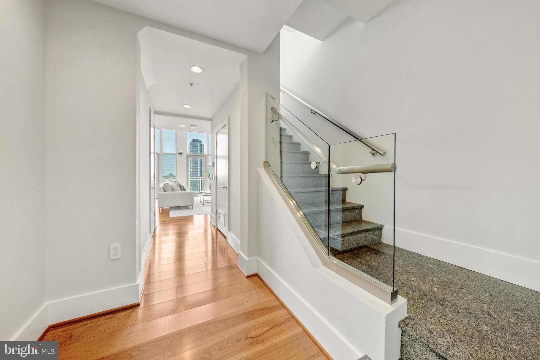 11990 Market Street, Unit 2112 Reston, VA 20190 - Photo 34 of 92 a view of a hallway with wooden floor and staircase