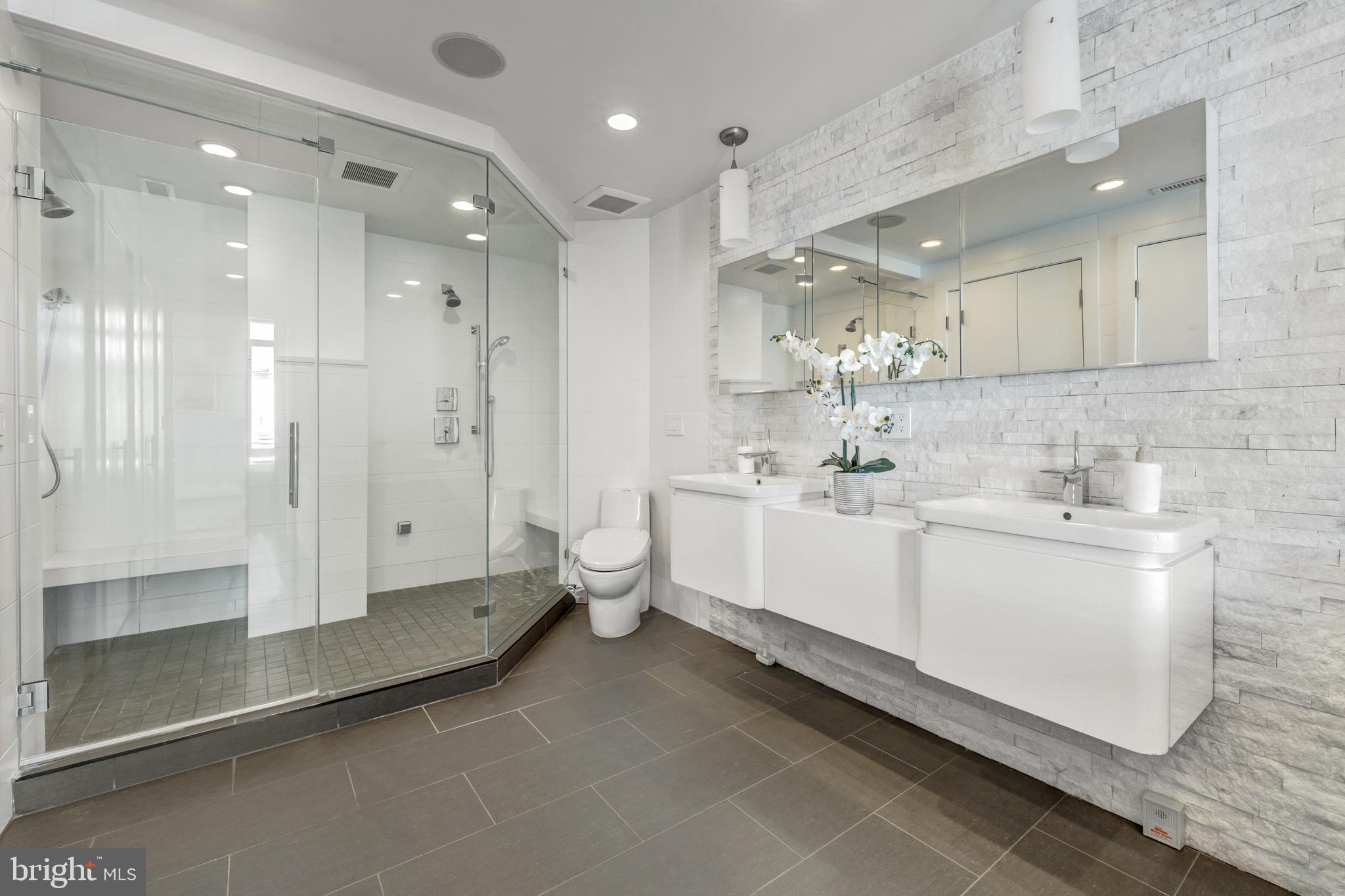 11990 Market Street, Unit 2112 Reston, VA 20190 - Photo 42 of 92 a bathroom with a double vanity sink mirror and shower