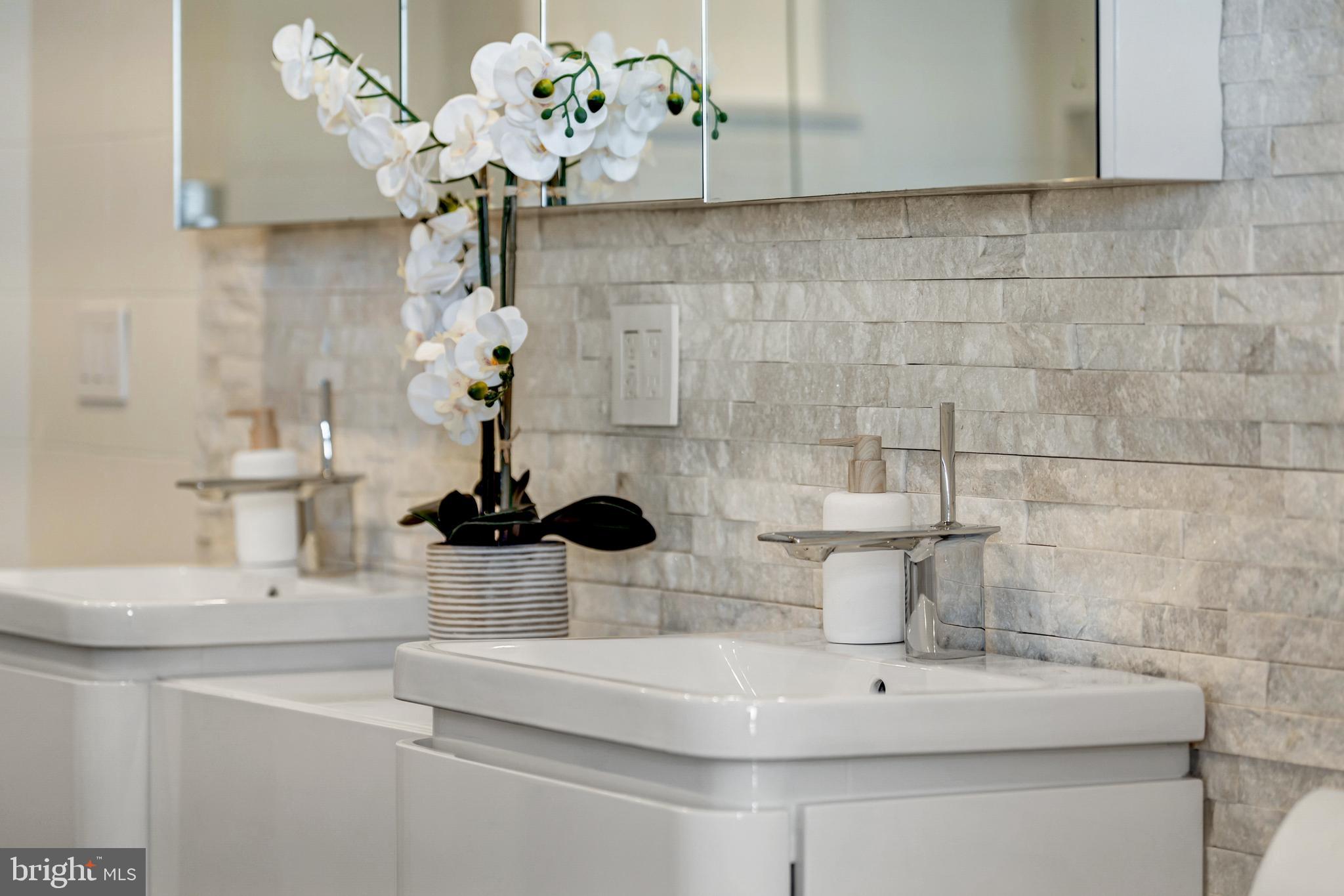 11990 Market Street, Unit 2112 Reston, VA 20190 - Photo 43 of 92 a bathroom with a sink a mirror and vanity