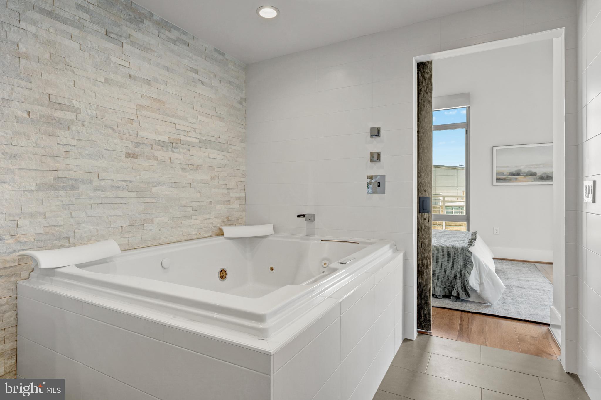 11990 Market Street, Unit 2112 Reston, VA 20190 - Photo 44 of 92 a bathroom with a tub and shower
