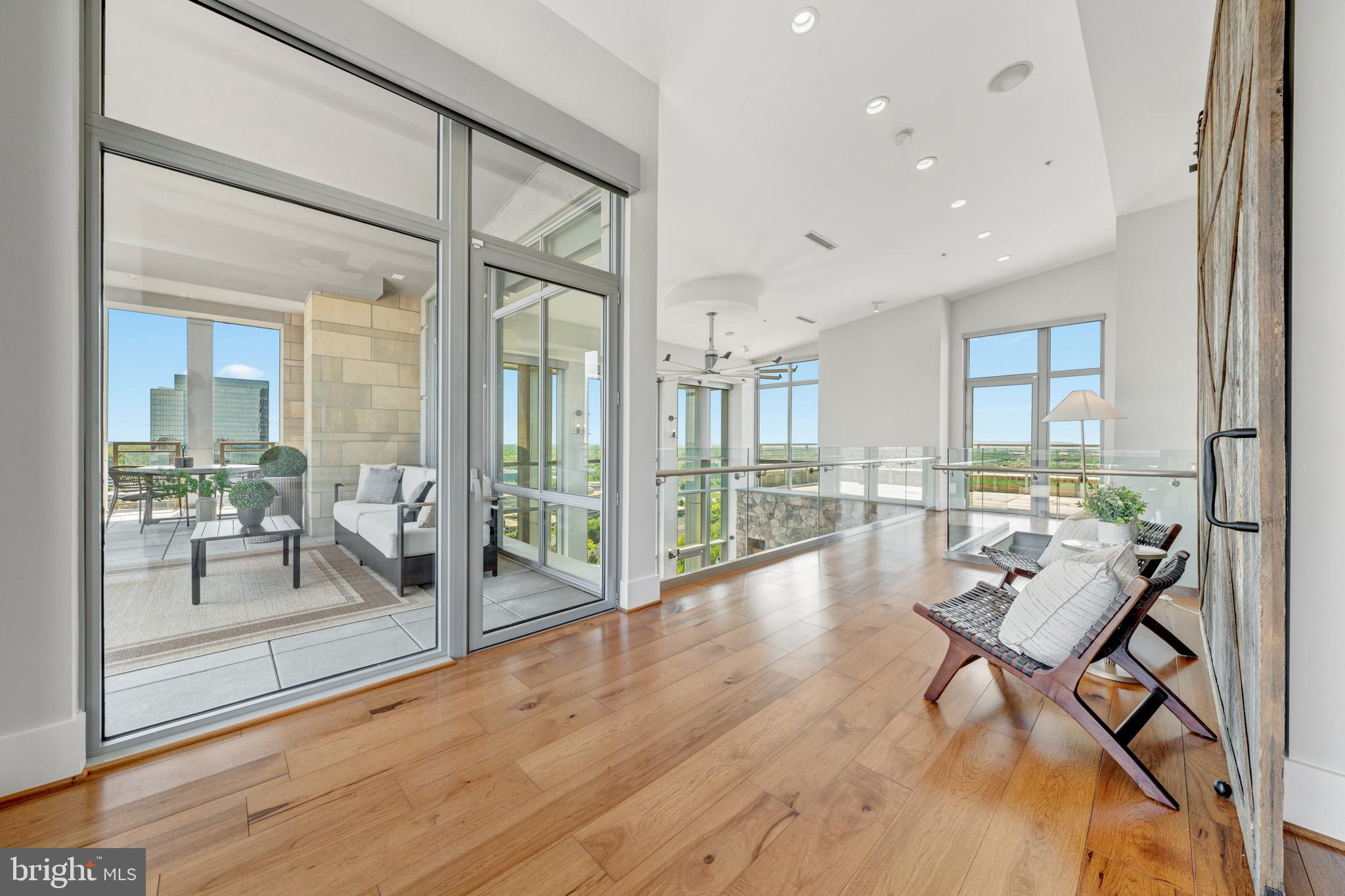 11990 Market Street, Unit 2112 Reston, VA 20190 - Photo 46 of 92 a living room with furniture and a floor to ceiling window