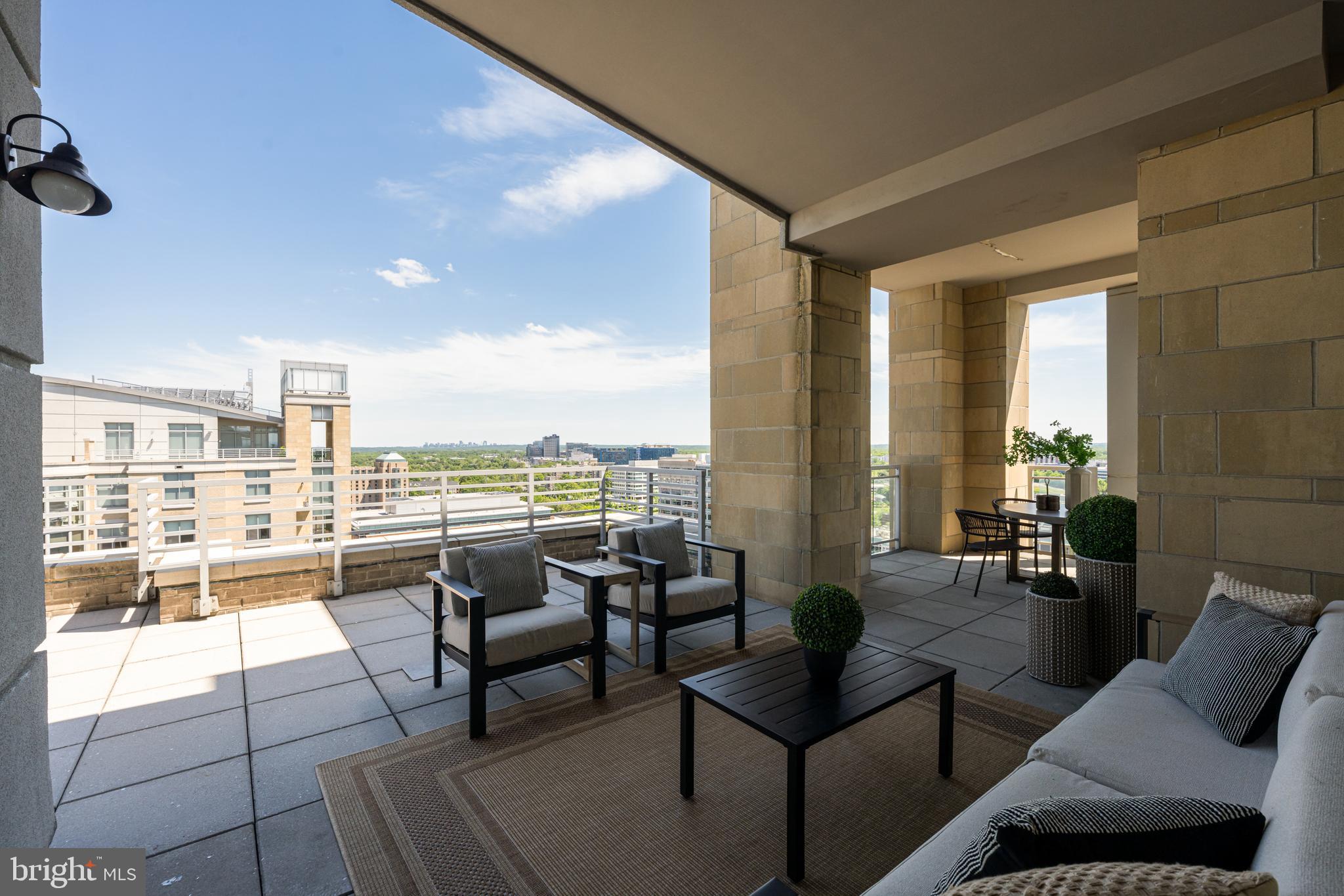 11990 Market Street, Unit 2112 Reston, VA 20190 - Photo 49 of 92 a living room with furniture and floor to ceiling windows