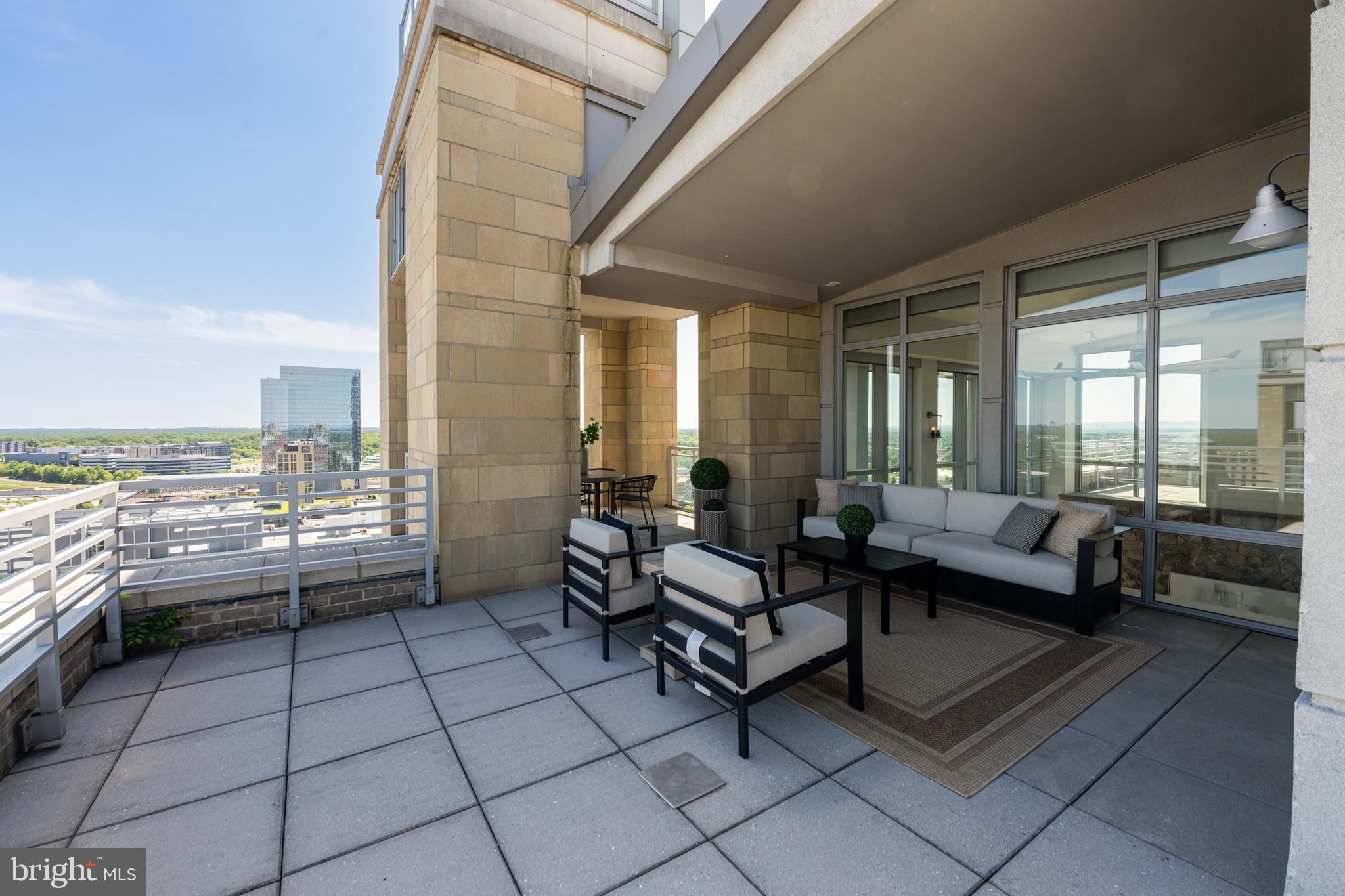 11990 Market Street, Unit 2112 Reston, VA 20190 - Photo 50 of 92 a living room with furniture and a floor to ceiling window