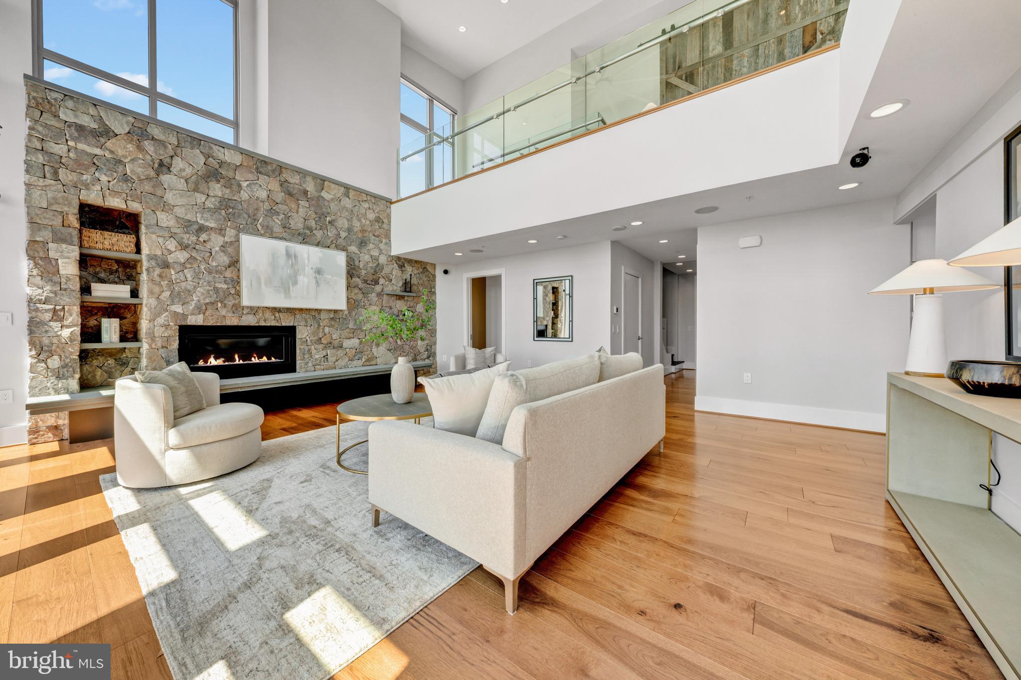 11990 Market Street, Unit 2112 Reston, VA 20190 - Photo 6 of 92 a living room with furniture and a fireplace