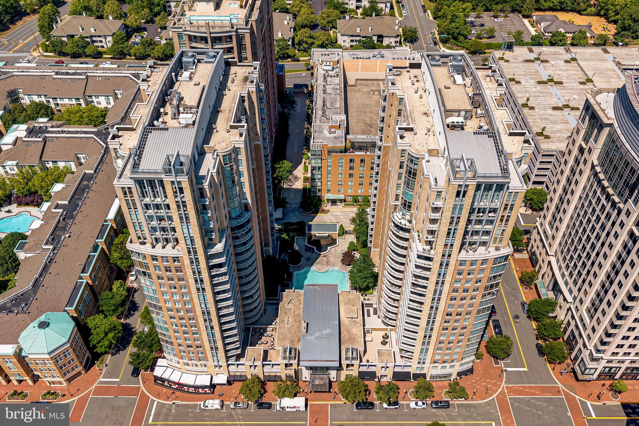 11990 Market Street, Unit 2112 Reston, VA 20190 - Photo 76 of 92 an aerial view of multi story residential apartment building with yard
