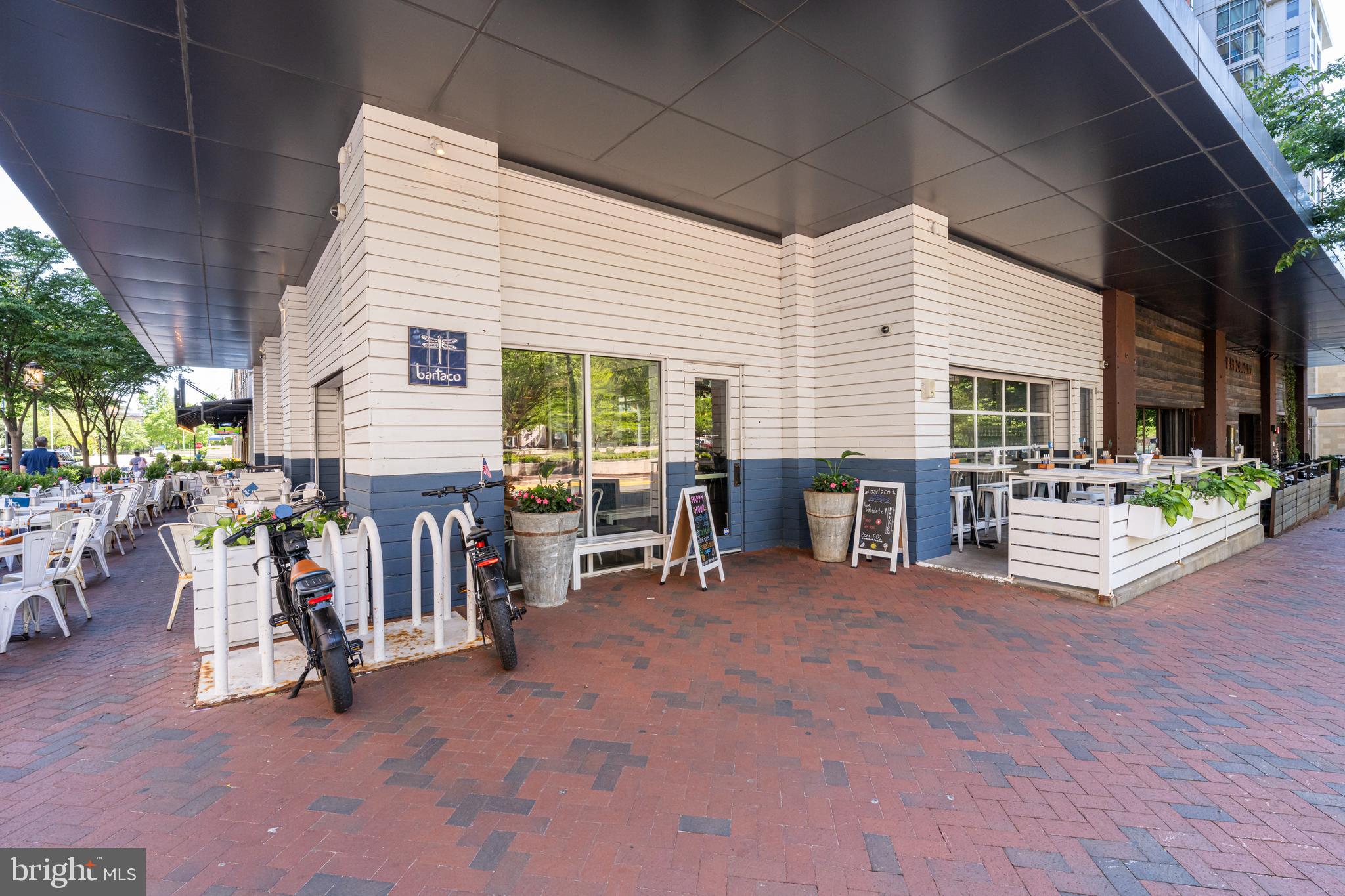 11990 Market Street, Unit 2112 Reston, VA 20190 - Photo 90 of 92 a view of a patio with table and chairs under an umbrella