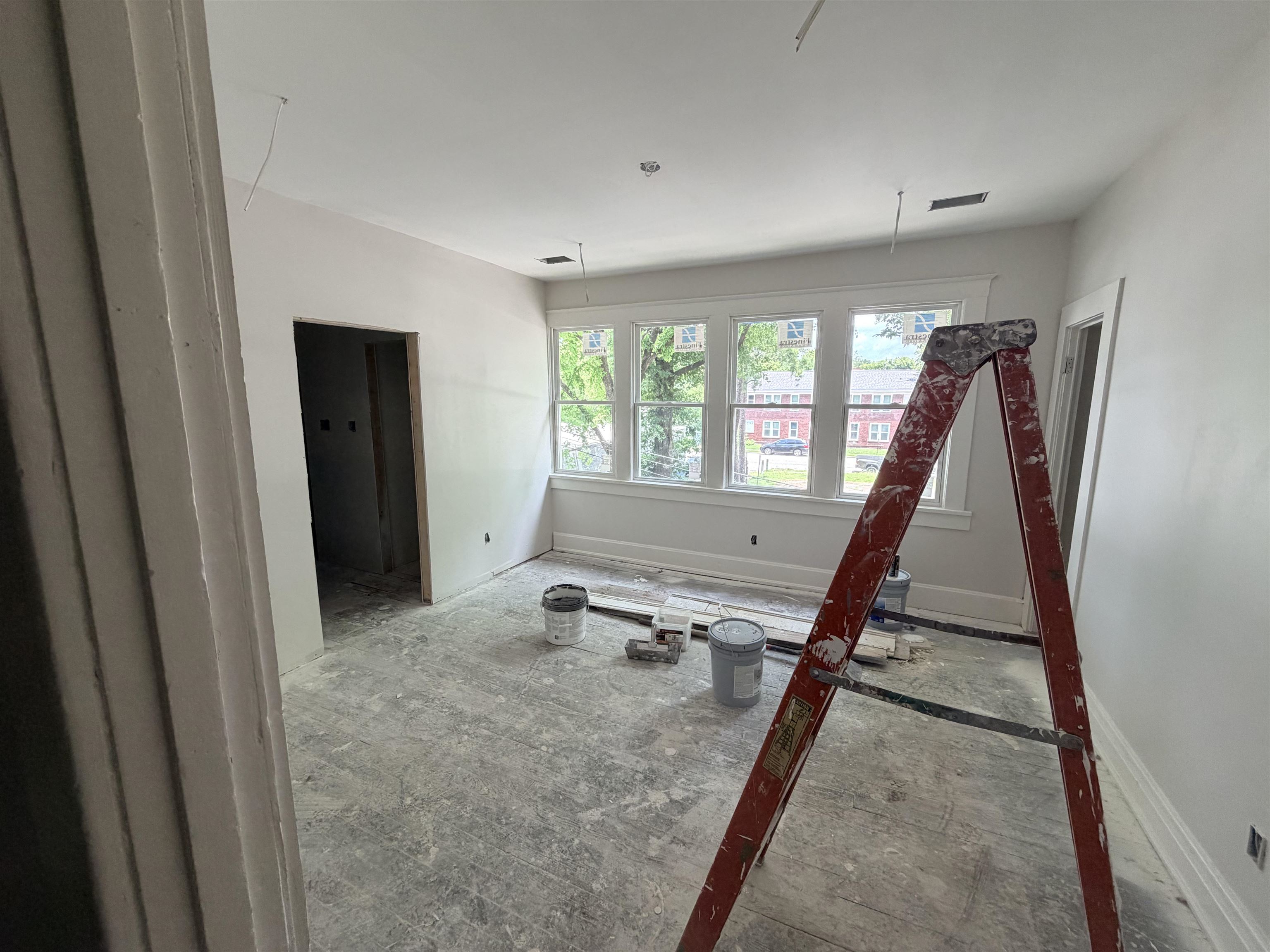 961 Meda Street Memphis, TN 38104 - Photo 13 of 27 Sunlit interior space featuring multiple windows with white trim, fresh white wall paint, and a neutral ceiling