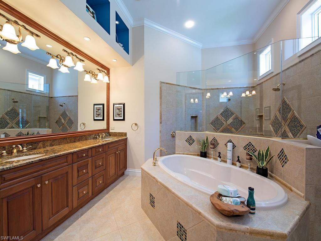 14903 Bellezza Lane Naples, FL 34110 - Photo 11 of 25 a bathroom with a granite countertop sink and a mirror
