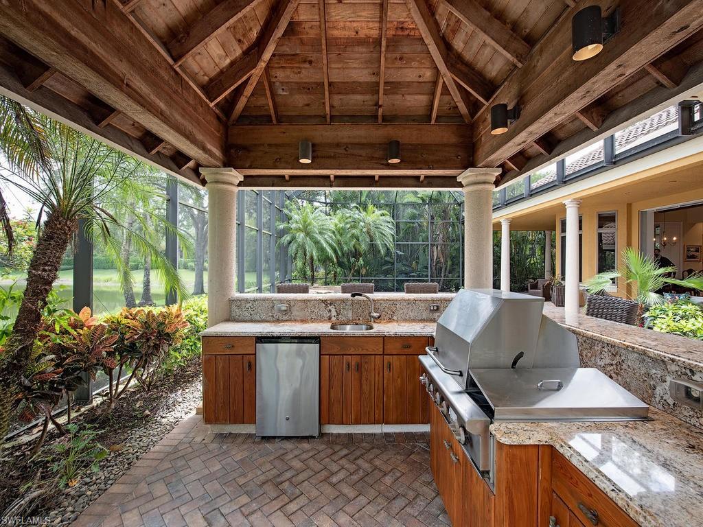 14903 Bellezza Lane Naples, FL 34110 - Photo 13 of 25 a outdoor dining space with furniture