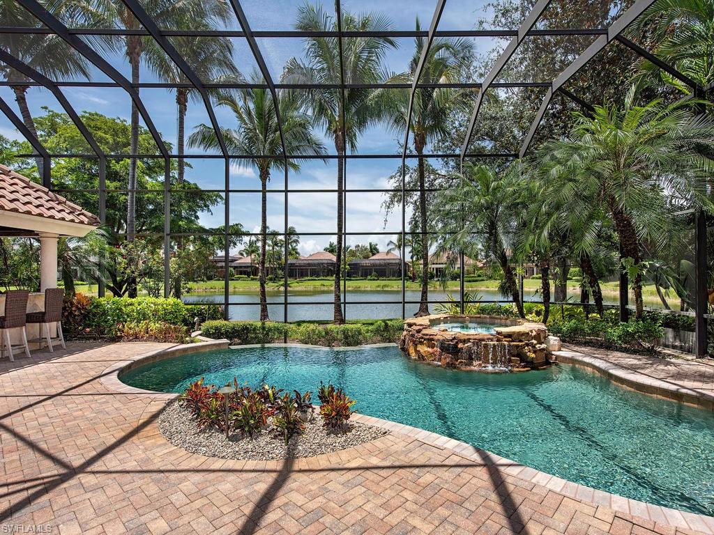14903 Bellezza Lane Naples, FL 34110 - Photo 14 of 25 a front view of a house with a yard table and chairs