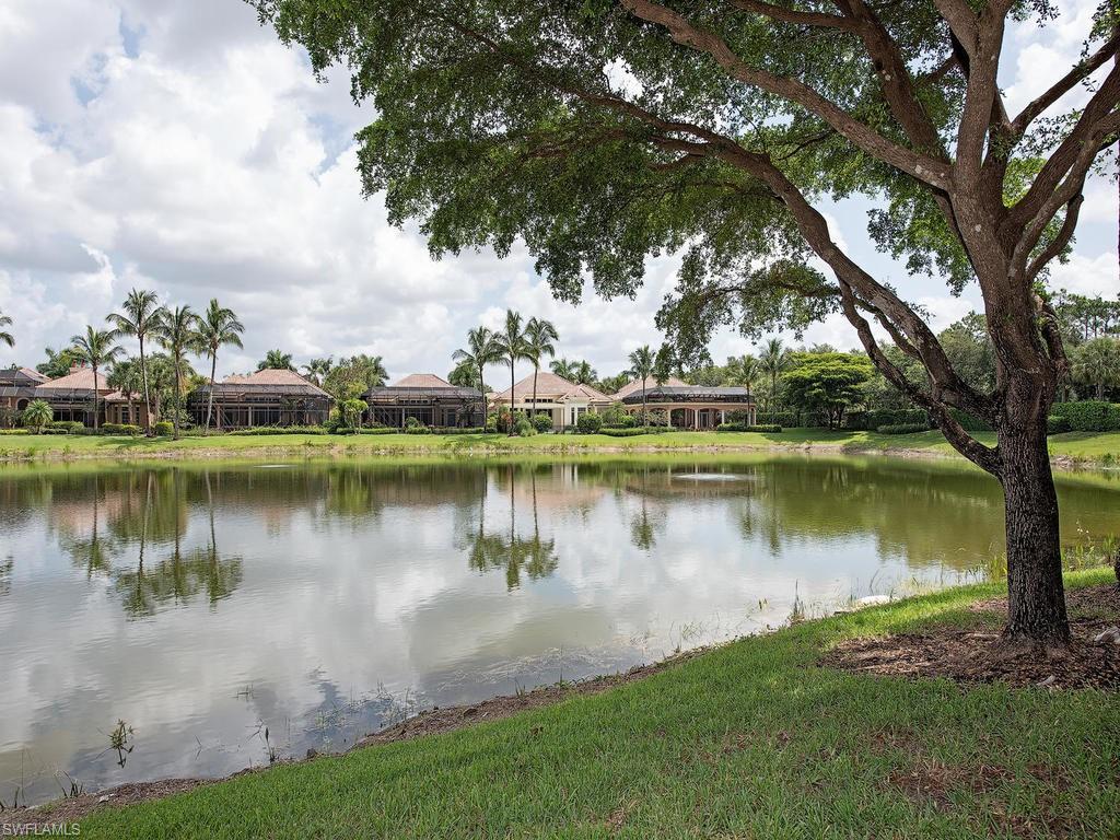 14903 Bellezza Lane Naples, FL 34110 - Photo 17 of 25 a view of a lake with a big yard and large trees