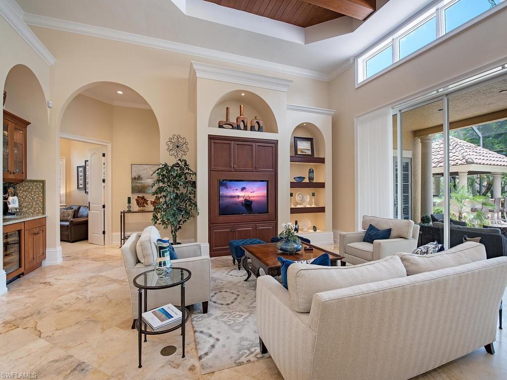 14903 Bellezza Lane Naples, FL 34110 - Photo 5 of 25 a living room with furniture a fireplace and a window