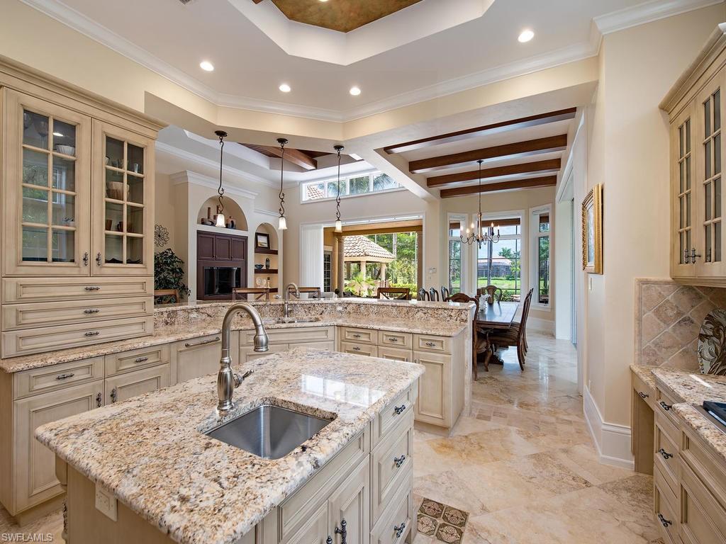14903 Bellezza Lane Naples, FL 34110 - Photo 7 of 25 a kitchen with stainless steel appliances granite countertop a sink and a refrigerator