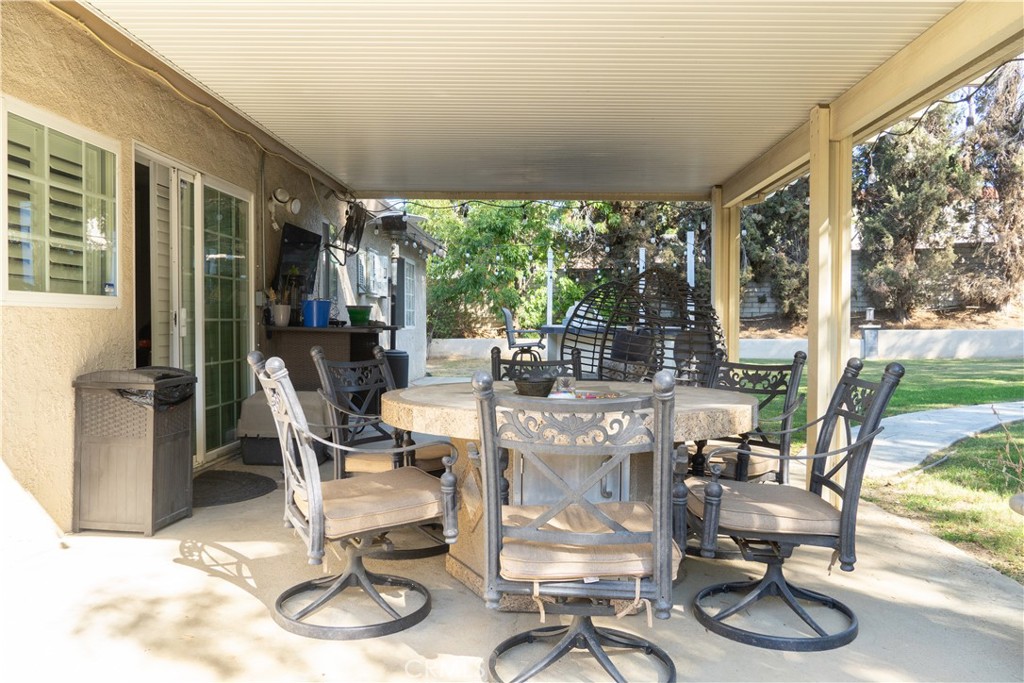 2122 Trafalgar Avenue Riverside, CA 92506 - Photo 13 of 18 a view of a dining room with furniture wooden floor and a floor to ceiling window