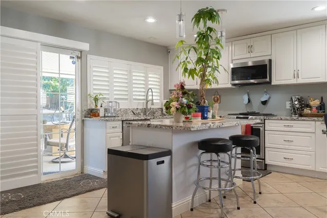 a kitchen with stainless steel appliances granite countertop a sink and cabinets