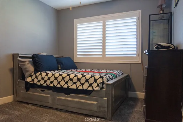 a bed sitting in a bedroom next to a window