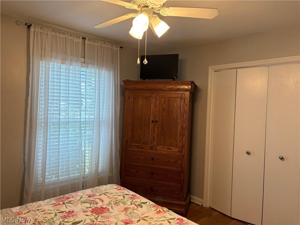 1440 West Miner Road Cleveland, OH 44124 - Photo 13 of 49 Bedroom featuring wood flooring, multiple windows, a closet, and ceiling fan